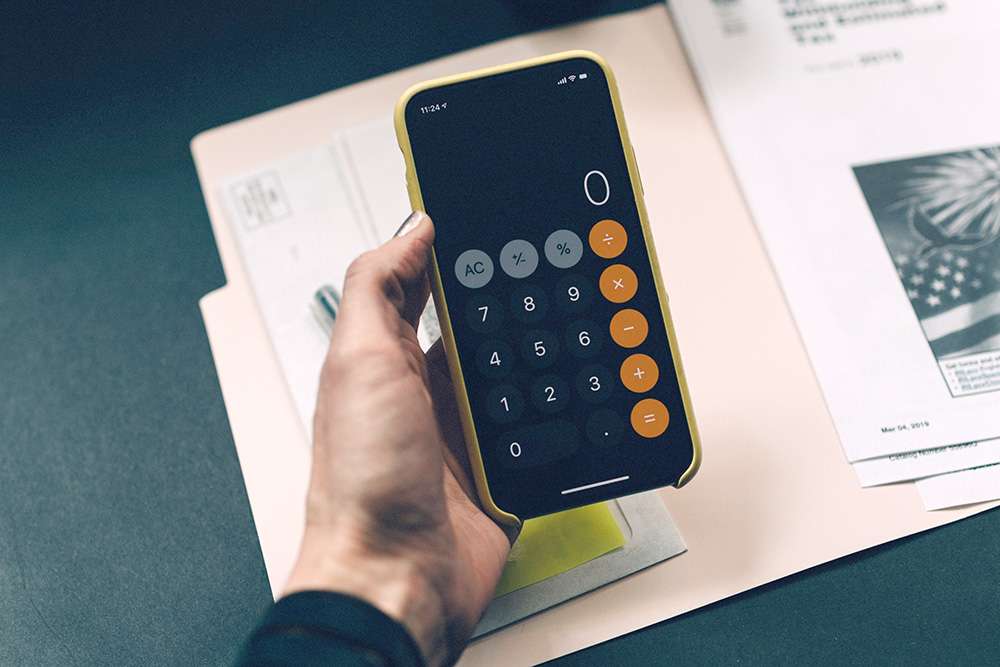 Image of a hand holding a calculator